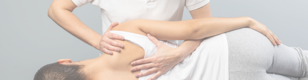 chiropractor stabilizing patients shoulder